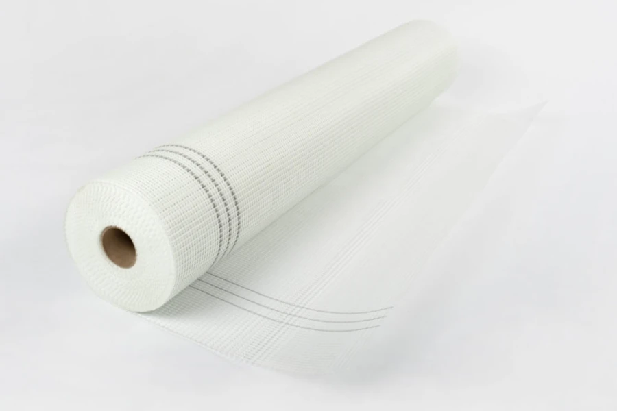 A roll of white fiberglass fabric placed on a white background.