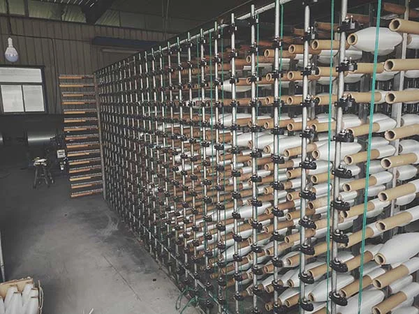 Fiberglass warp yarns prepared and arranged for the weaving process
