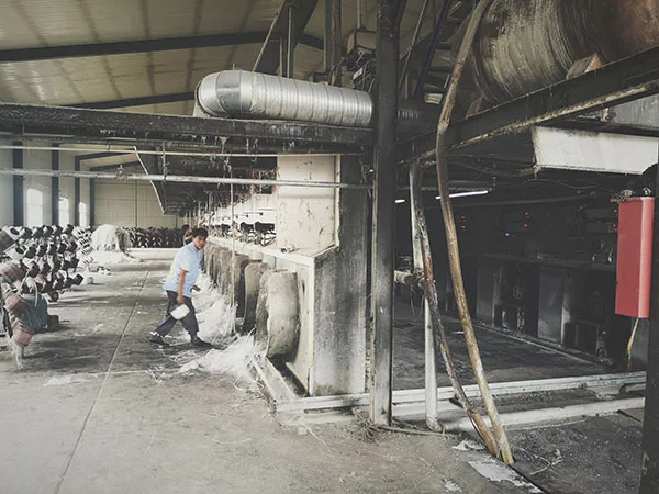 Fiberglass yarns being drawn from a production machine