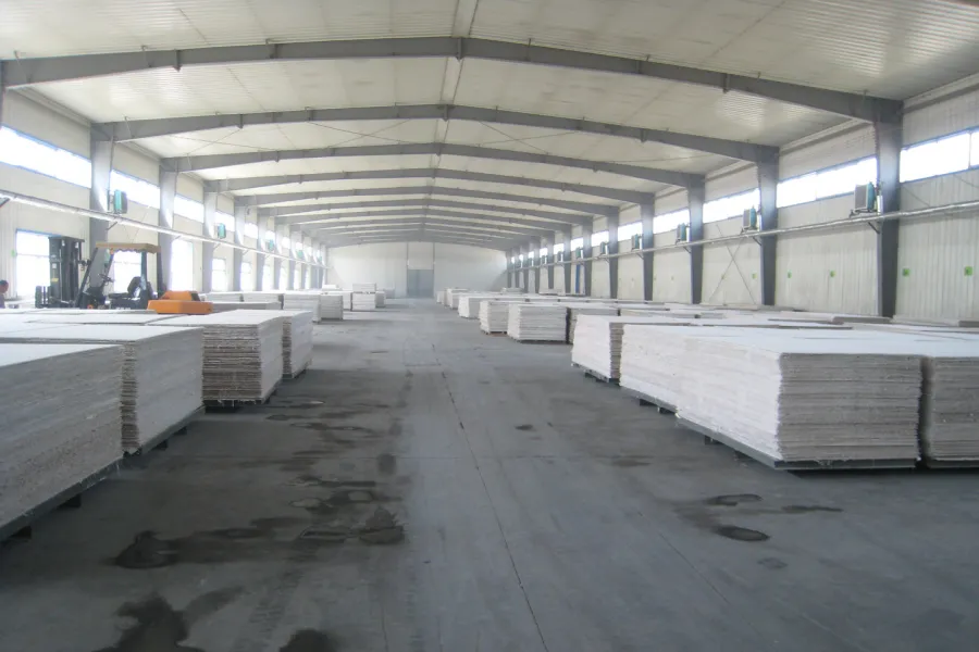 Magnesium oxide (MgO) boards stacked on pallets in a manufacturing facility